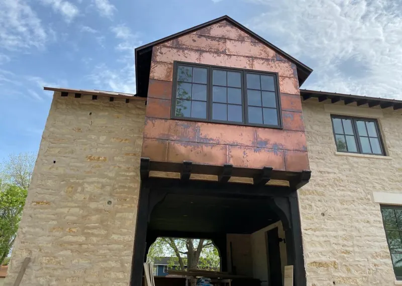 Copper metal panel facade on a stone building for Skylight Installation in Ellicott