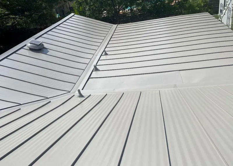 Solar attic fan installed on a metal roof for Roof Ventilation in Ellicott